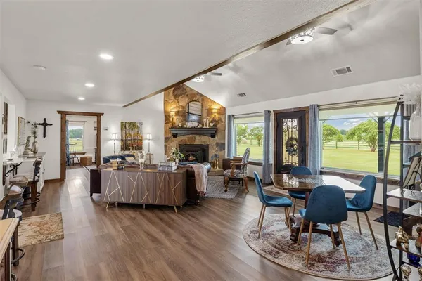 a living room with fireplace furniture and a large window