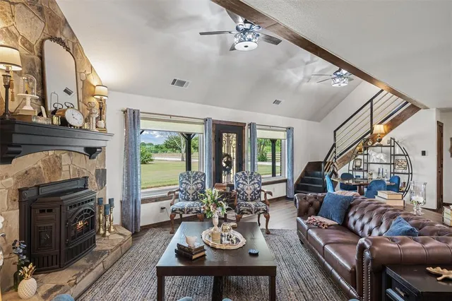 a kitchen with stainless steel appliances granite countertop a sink a stove and a wooden floors