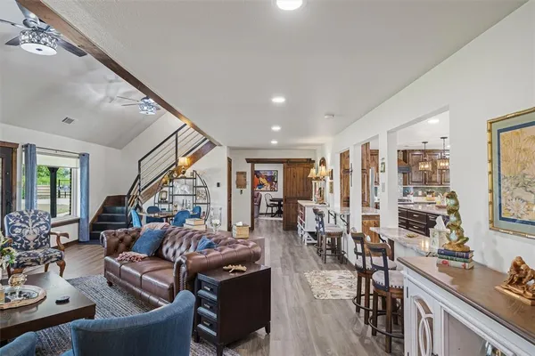 a living room with lots of furniture and hard wood flooring