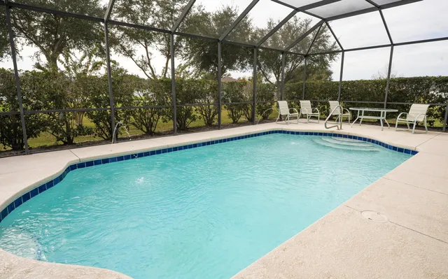 a view of dining room and kitchen with a large window