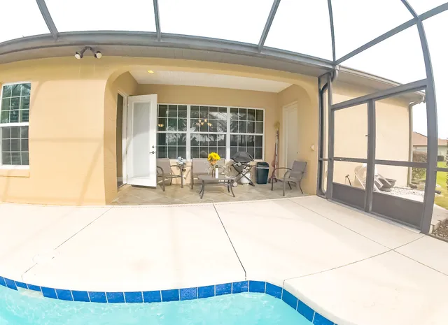 a view of a dining room with furniture wooden floor and chandelier