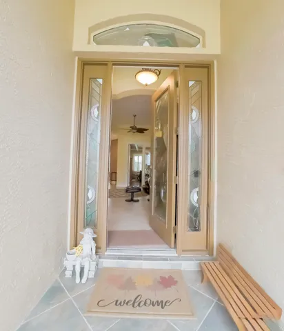 a dining room with wooden floor a chandelier a wooden table and chairs