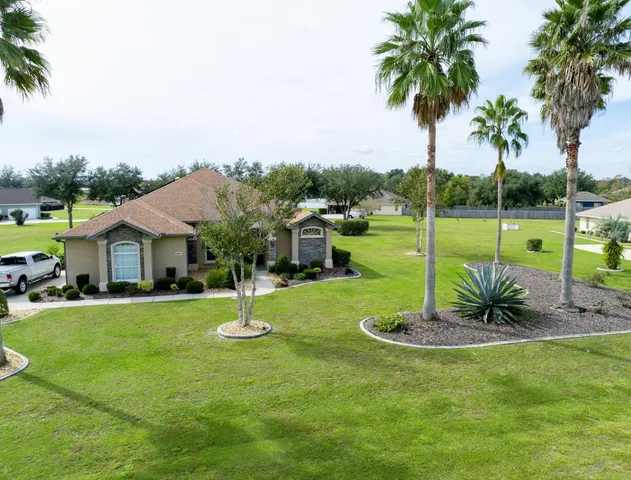 an aerial view of a garden with lawn chairs