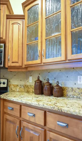 a spacious bathroom with a granite countertop sink and a mirror