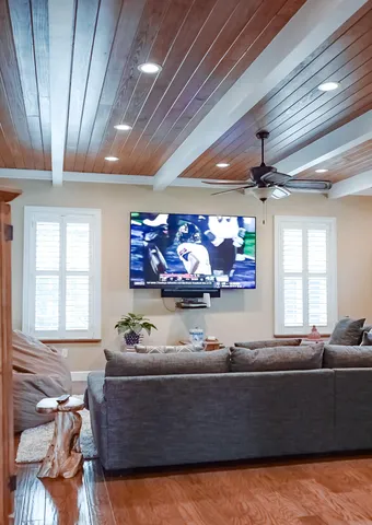 a spacious bedroom with a bed and a chandelier