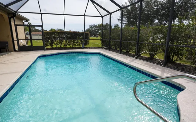 a view of living room filled with furniture and a chandelier