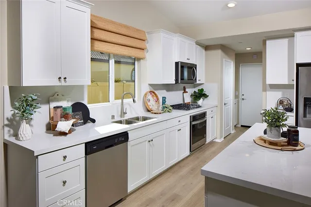 a kitchen with sink refrigerator and stove