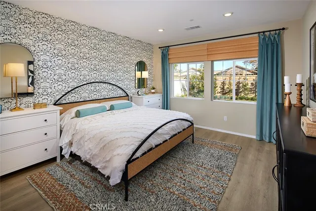 a bedroom with a large bed and a window