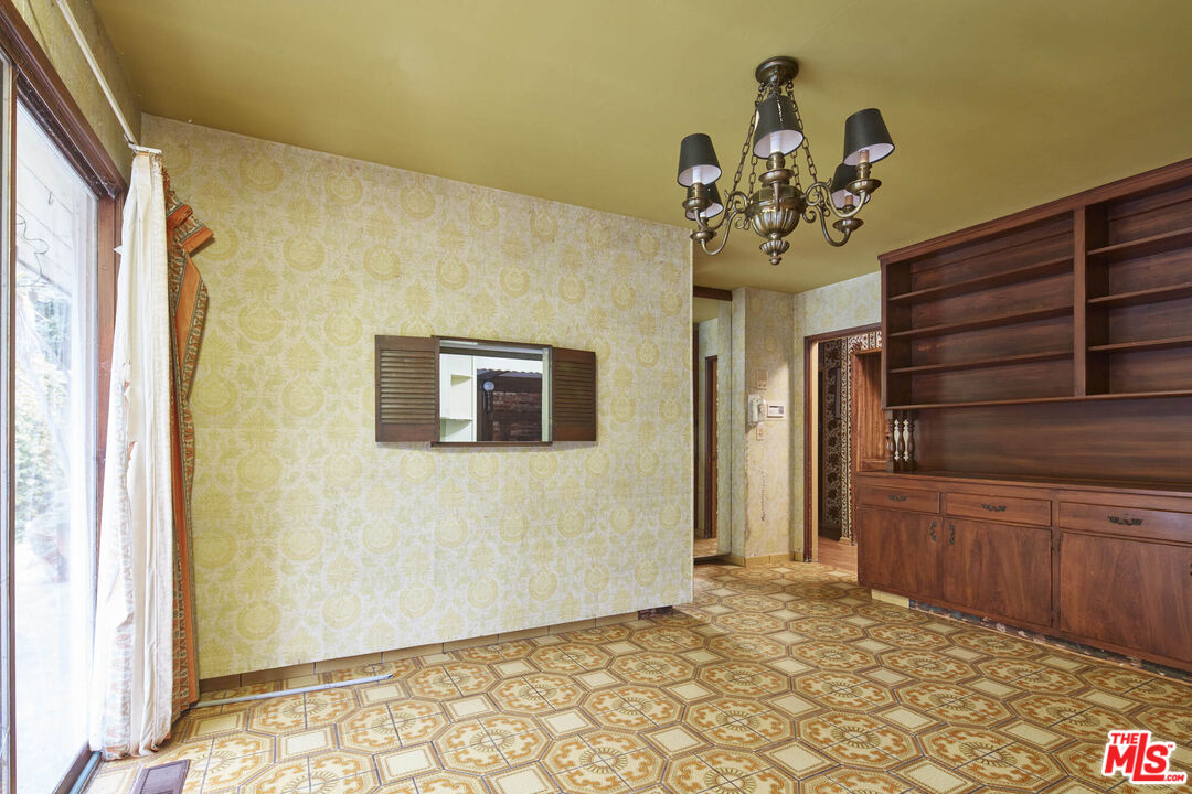 6414 Bonsall Drive Malibu, CA 90265 - Photo 22 of 75 a view of a hallway with wooden floor and chandelier