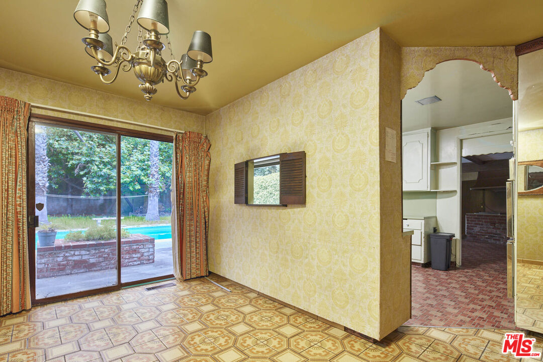 6414 Bonsall Drive Malibu, CA 90265 - Photo 23 of 75 a view of a livingroom with a chandelier potted plants and wooden floor