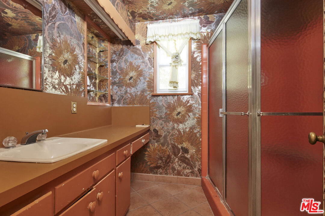 6414 Bonsall Drive Malibu, CA 90265 - Photo 27 of 75 a bathroom with a sink and mirror