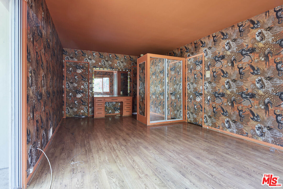 6414 Bonsall Drive Malibu, CA 90265 - Photo 32 of 75 a view of an empty room with a window and wooden floor