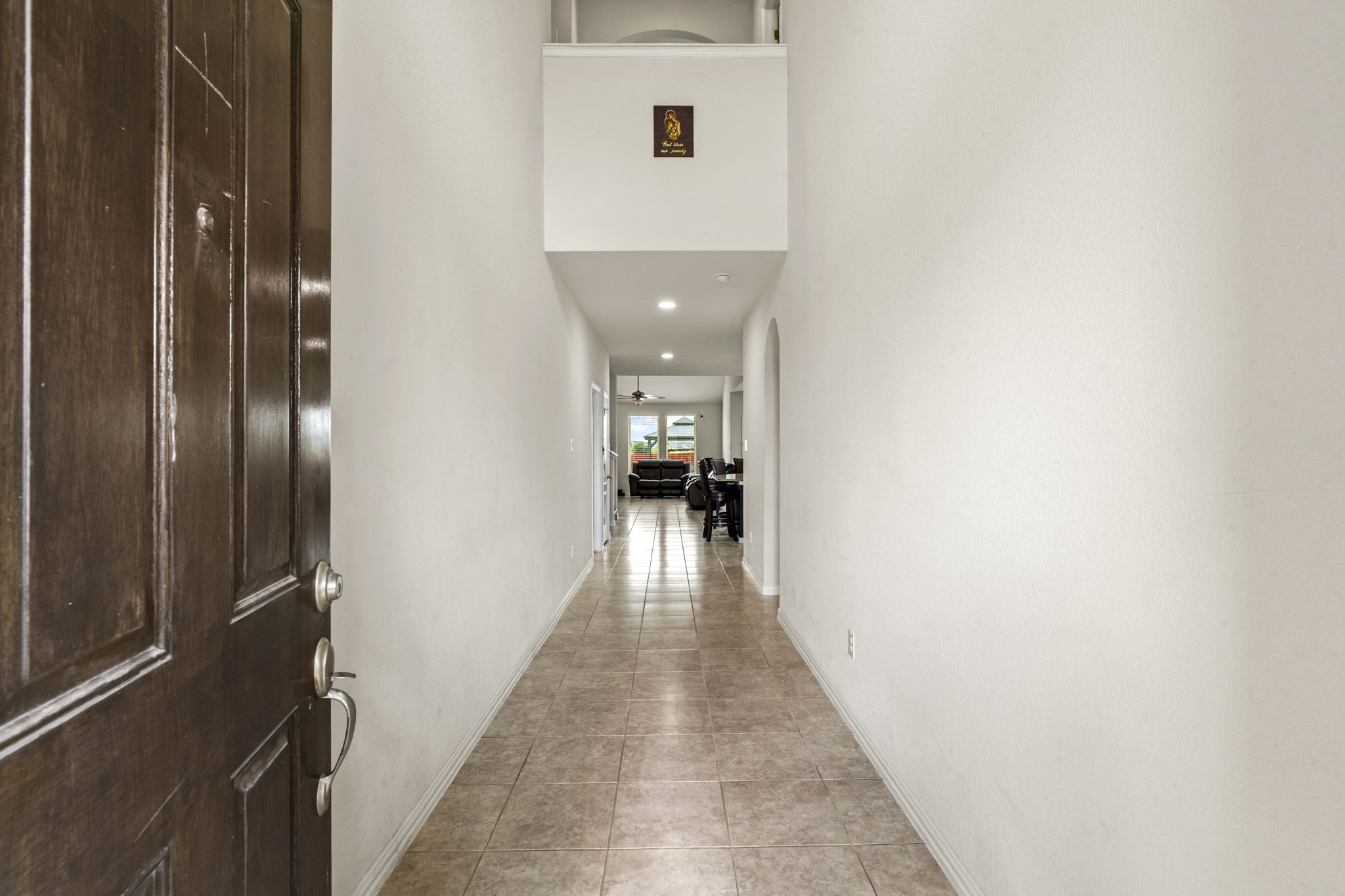 373 Rough Bark Street Buda, TX 78610 - Photo 3 of 39 A welcoming entryway with cool tile flooring leads into an open living space.
