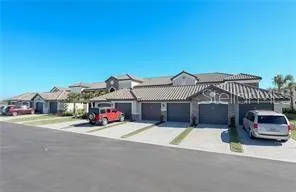 a view of a house with a cars park in front of it