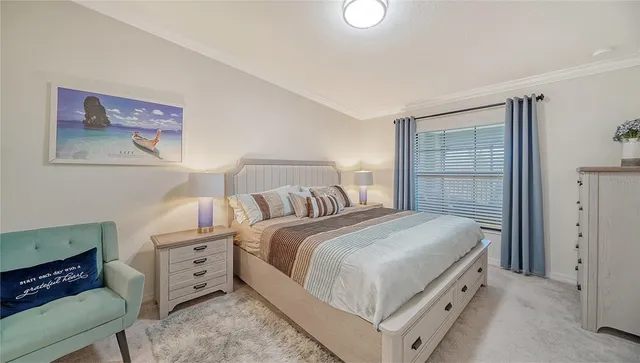 a bedroom with a bed and a painting on the wall