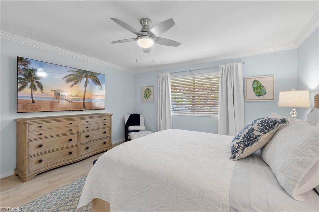 1435 Curlew Avenue, Unit 3 Naples, FL 34102 - Photo 12 of 28 a bedroom with a bed and a dresser