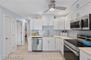 1435 Curlew Avenue, Unit 3 Naples, FL 34102 - Photo 14 of 28 a kitchen with a sink a stove and cabinets