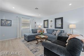 1435 Curlew Avenue, Unit 3 Naples, FL 34102 - Photo 17 of 28 a living room with furniture and a lamp