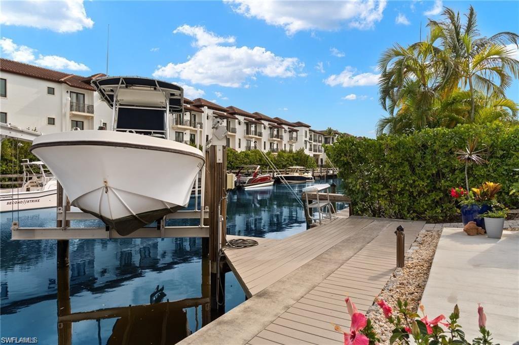 1435 Curlew Avenue, Unit 3 Naples, FL 34102 - Photo 20 of 28 a view of a balcony with two chairs and a table
