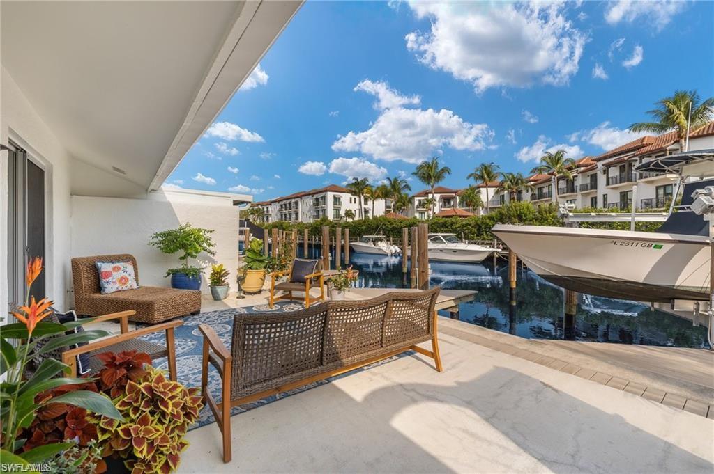 1435 Curlew Avenue, Unit 3 Naples, FL 34102 - Photo 2 of 28 a living room with patio furniture and a potted plant