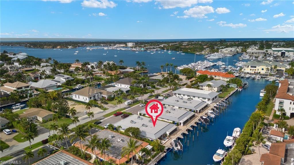 1435 Curlew Avenue, Unit 3 Naples, FL 34102 - Photo 22 of 28 an aerial view of beach and residential space with swimming pool