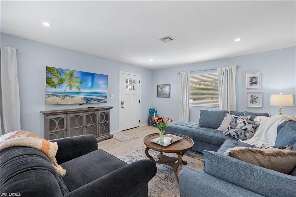 1435 Curlew Avenue, Unit 3 Naples, FL 34102 - Photo 4 of 28 a living room with furniture and a flat screen tv