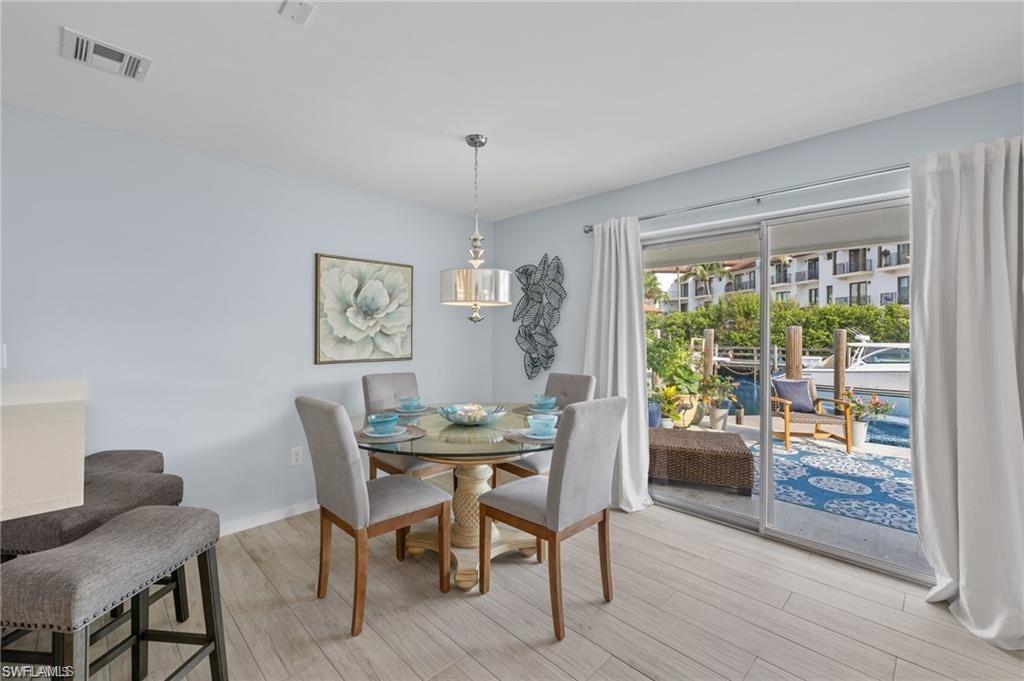1435 Curlew Avenue, Unit 3 Naples, FL 34102 - Photo 8 of 28 a view of a dining room with furniture window and wooden floor