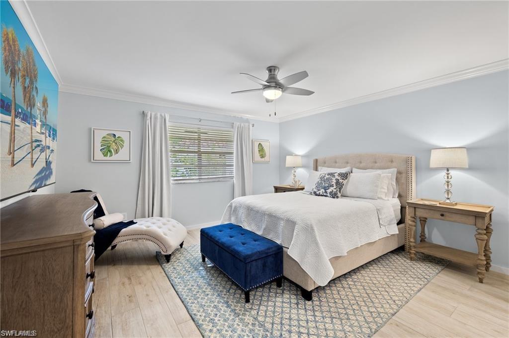 1435 Curlew Avenue, Unit 3 Naples, FL 34102 - Photo 9 of 28 a bedroom with a bed and a couch