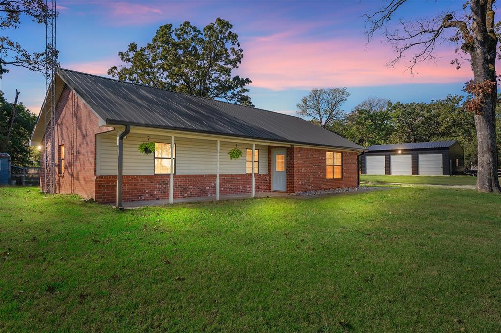 a view of a house with a backyard