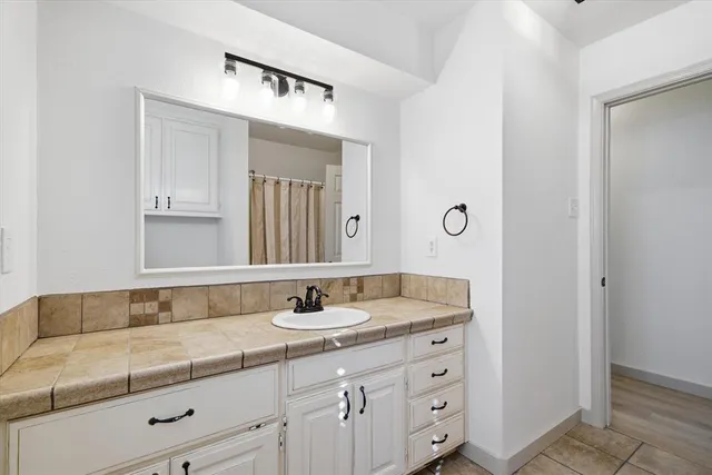 a bathroom with a sink and a mirror