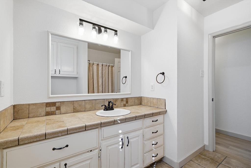 3360 Fm 1805 Van, TX 75790 - Photo 23 of 40 a bathroom with a sink and a mirror
