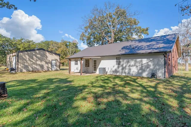 a view of a house with a yard and sitting area