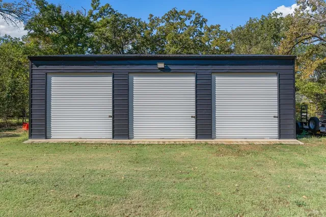 a view of small house with yard space