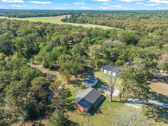 an aerial view of a house with a yard