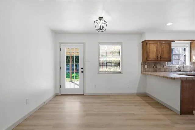 a view of kitchen and window with wooden floor