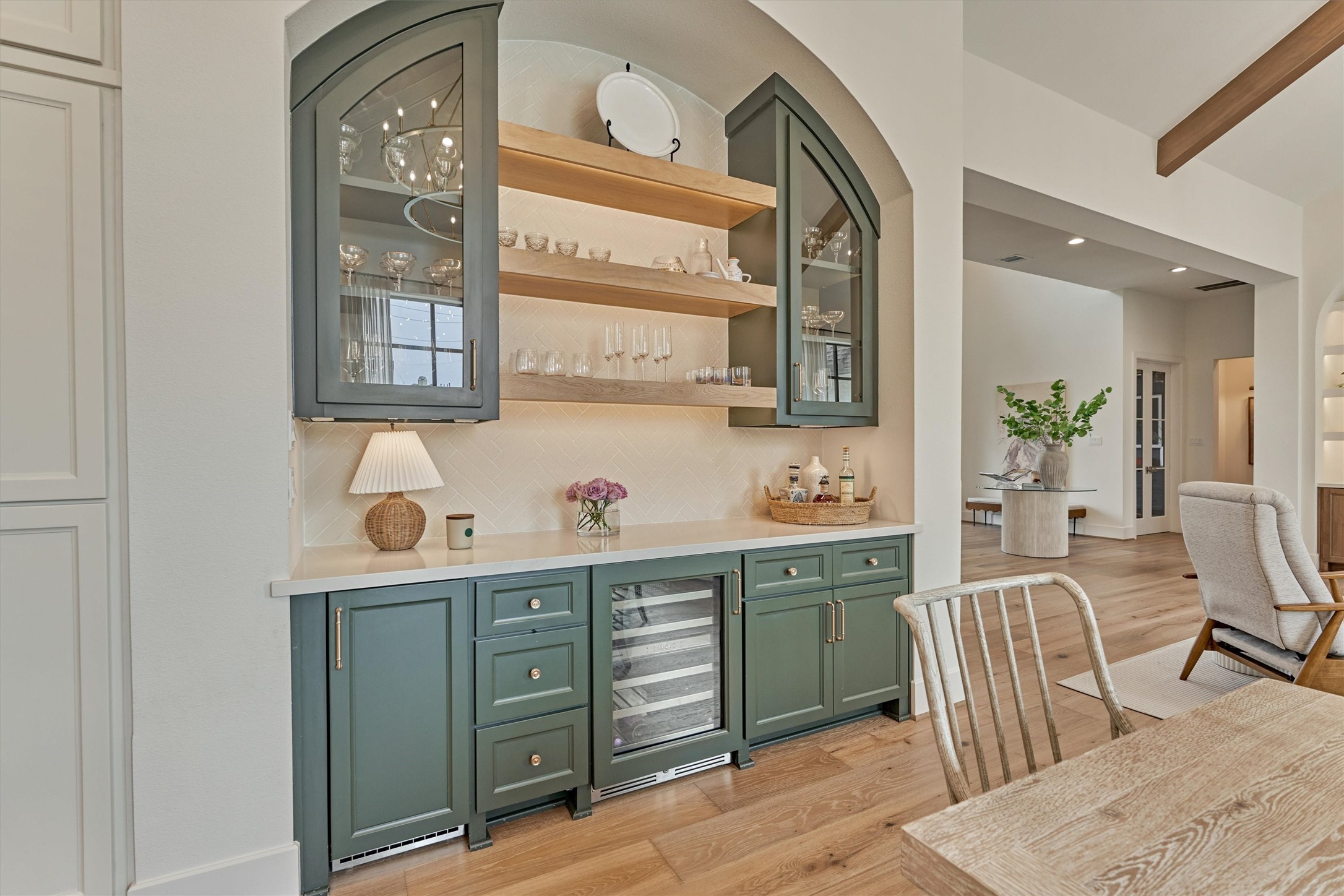 7715 Morgans Pond Court Spring, TX 77389 - Photo 12 of 50 Built-in coffee center with Landmark wine refrigerator, Scotsman ice maker, water connections, open shelving, and glass display cabinets.