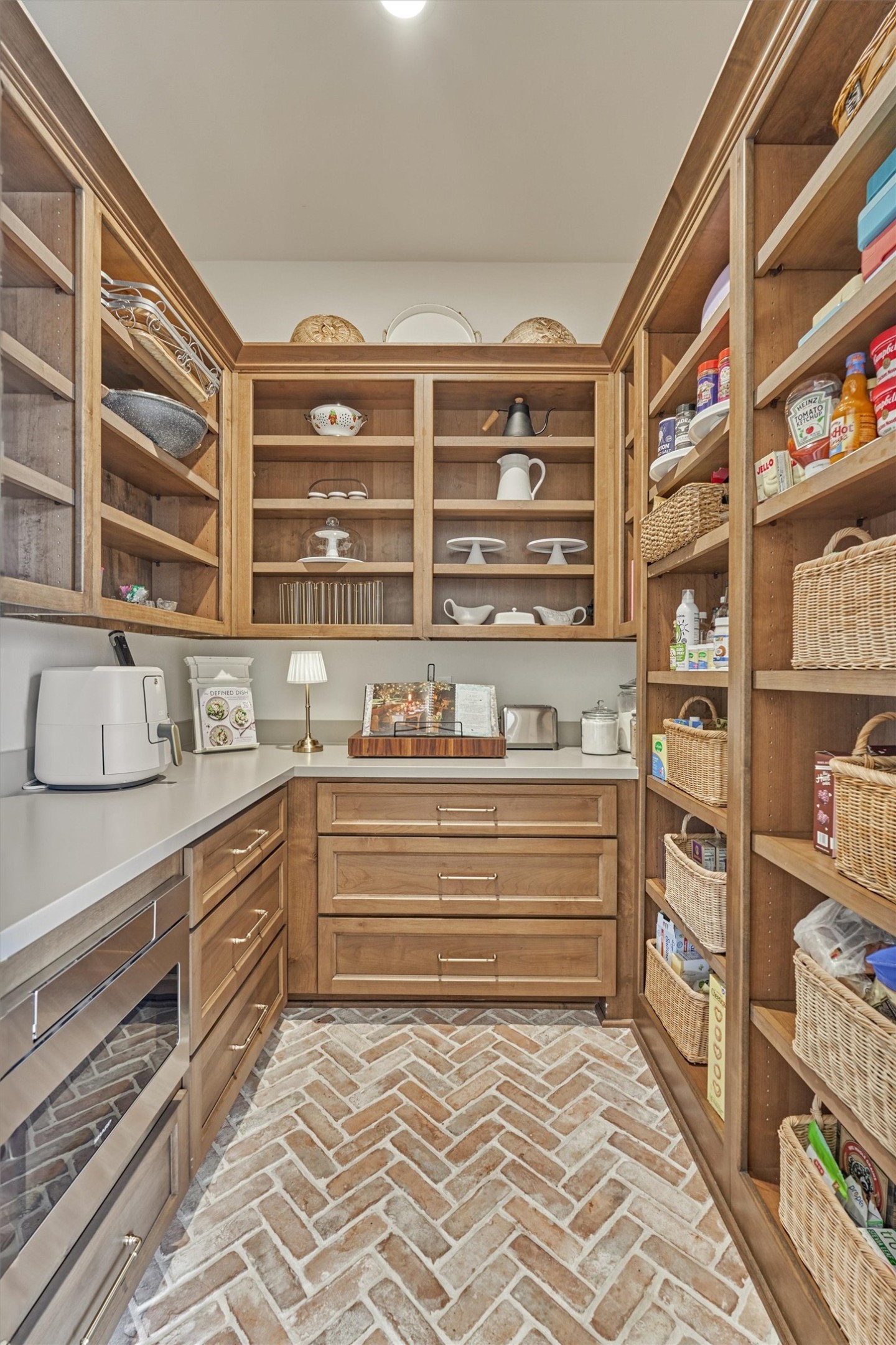 7715 Morgans Pond Court Spring, TX 77389 - Photo 16 of 50 Antique pantry doors to the amazing extensive butler’s pantry with quartz counters, natural stained custom shelves – cabinetry, herringbone laid brick floor and Sharp microwave drawer.