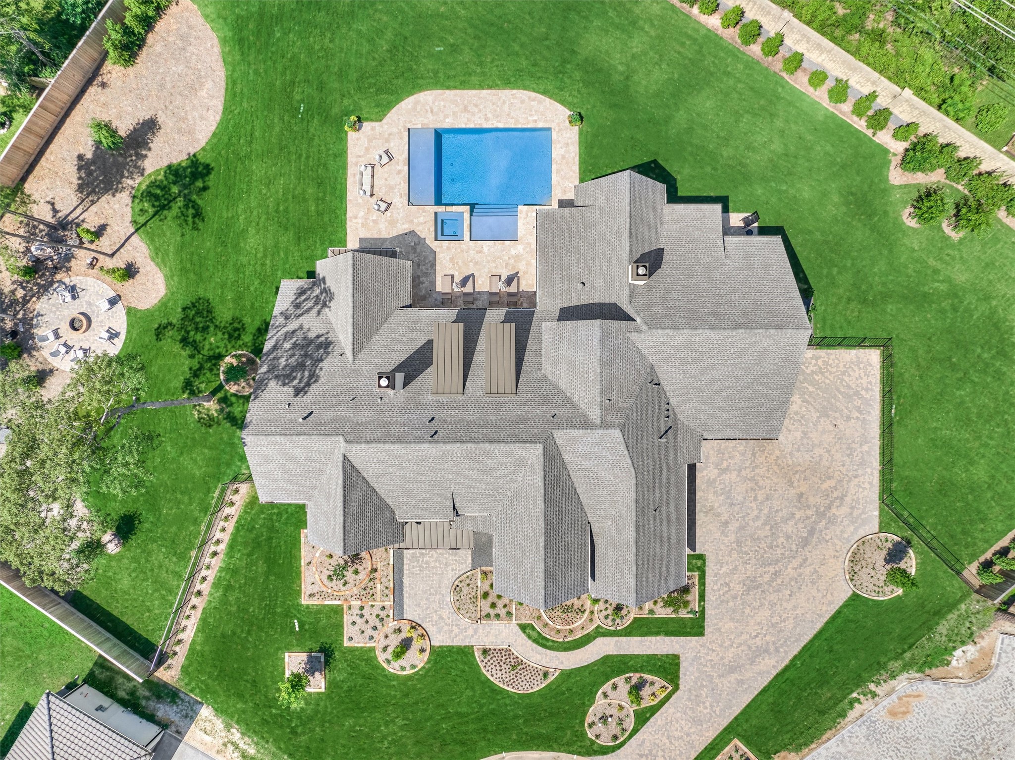 7715 Morgans Pond Court Spring, TX 77389 - Photo 39 of 50 Expansive private backyard, room for gardens, gorgeous pool with large sun shelf and spa, playground equipment, trampoline, mosquito misting system, Zoysia grass, pool bath, and more.