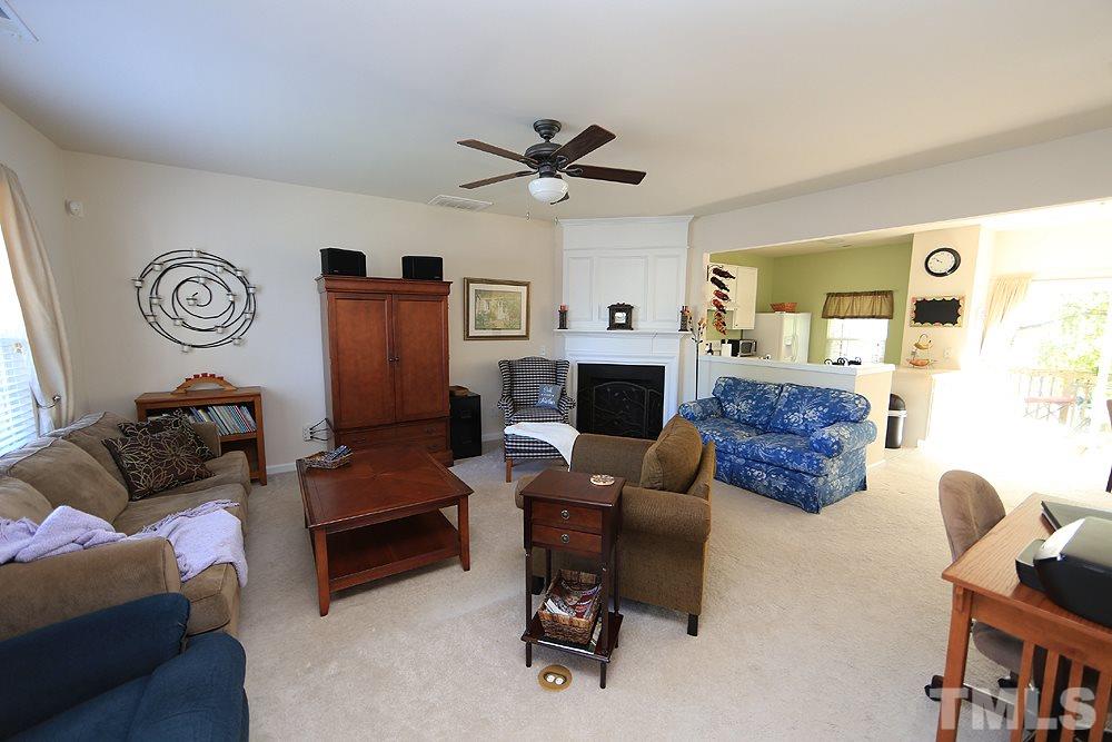 8113 Rhiannon Road Raleigh, NC 27613 - Photo 2 of 12 a living room with furniture and a fireplace