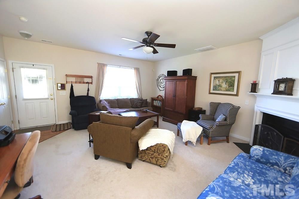 8113 Rhiannon Road Raleigh, NC 27613 - Photo 3 of 12 a living room with furniture ceiling fan and a rug