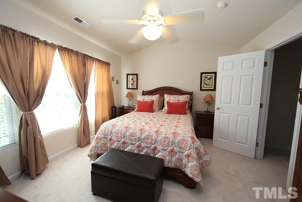 8113 Rhiannon Road Raleigh, NC 27613 - Photo 6 of 12 a bedroom with a bed closet and a large window