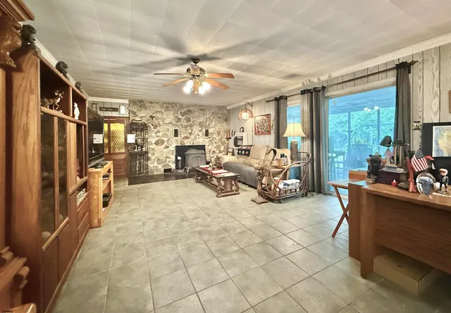 a view of a livingroom with furniture and a large window