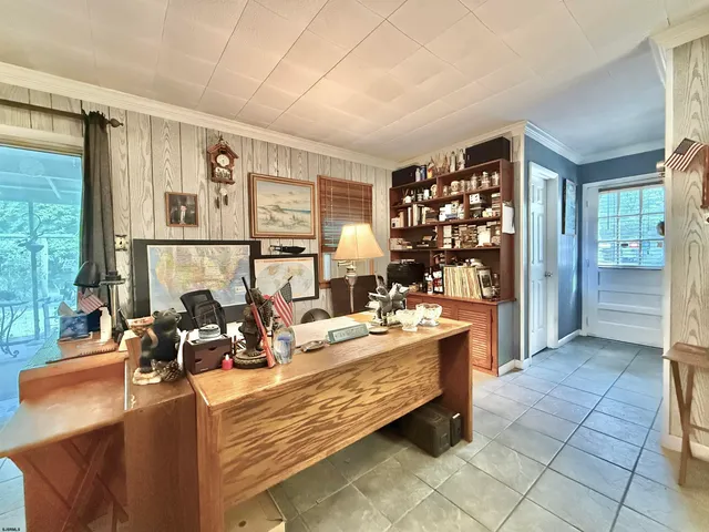 a living room with furniture and large window