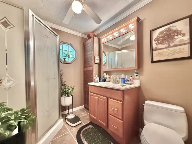 a bathroom with a granite countertop sink mirror vanity and toilet