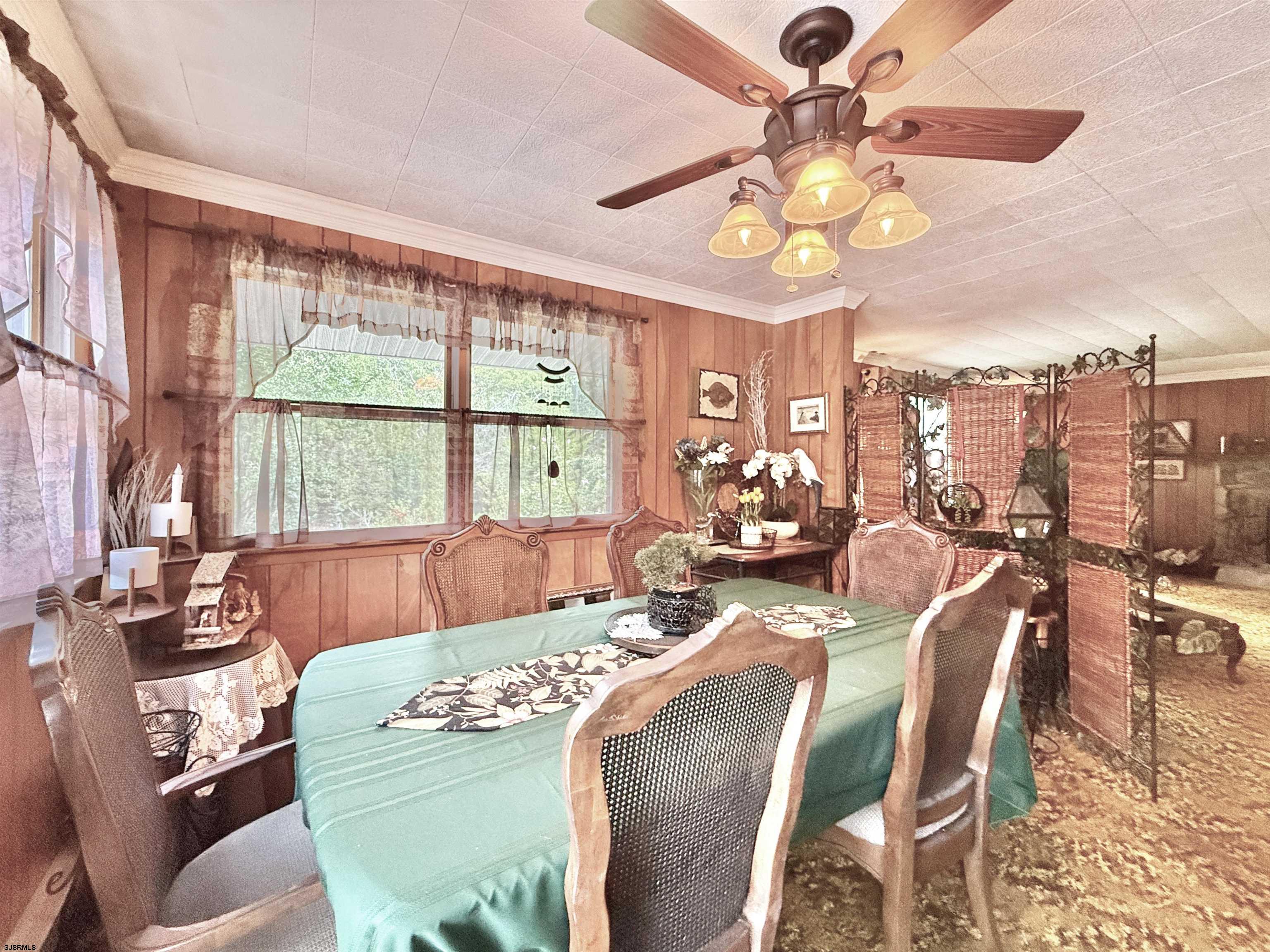 506 Hagan Road Cape May Court House, NJ 08210 - Photo 30 of 45 a view of a dining room with furniture a chandelier and a large window