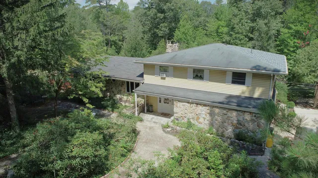 a front view of a house with yard and green space