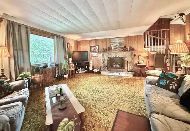 a living room with furniture large window and a table
