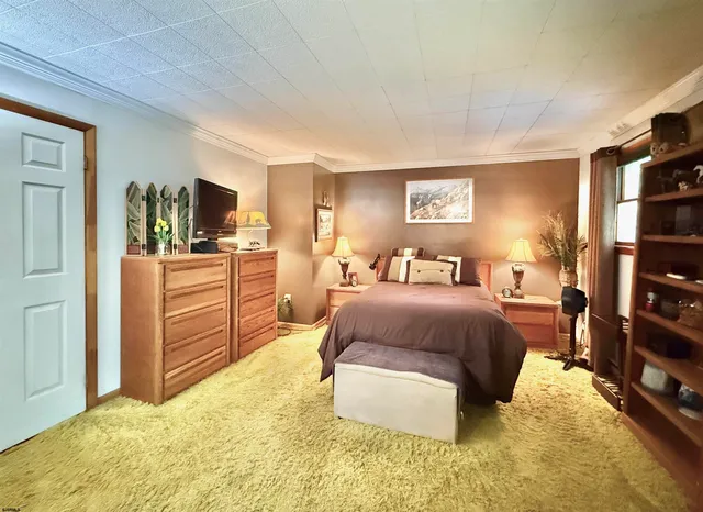 a spacious bedroom with a bed and furniture