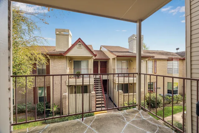 a view of a brick house with a large window