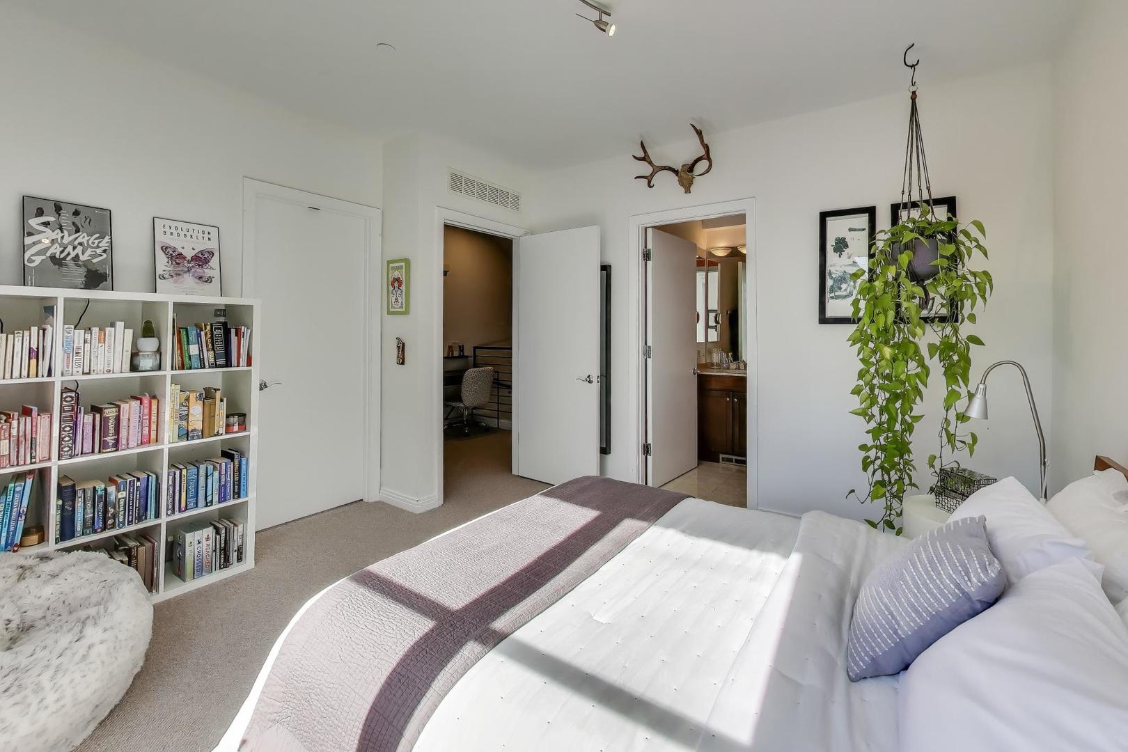 1137 West Monroe Street, Unit 9 Chicago, IL 60607 - Photo 15 of 31 a bedroom with a bed and a book shelf
